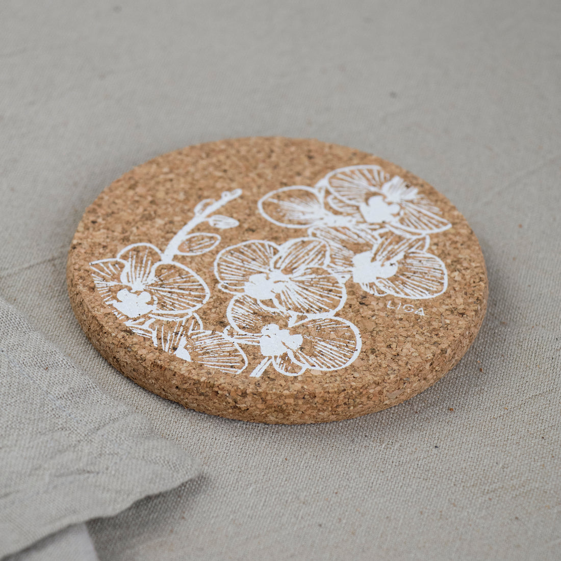 cork coaster with white orchid design